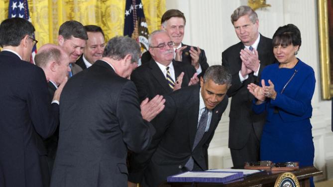 Law makers and cabinet officials applaud President Barack Obama after he signed H.R. 2146 Defending Public Safety Employees Retirement Act and H.R. 1295 Trade Preferences Extension Act of 2015, Monday, June 29, 2015, in the East Room of the White House in Washington. The president signed into law two hard-fought bills giving him greater authority to negotiate international trade deals and providing aid to workers whose jobs are displaced by such pacts. Commerce Secretary Penny Pritzker is at right. (AP Photo/Evan Vucci)