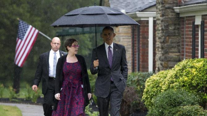President Barack Obama walks with Kelly Bryant at her home in Nashville, Tenn., Wednesday, July 1, 2015, en route to Taylor Stratton Elementary School, where he is to speak about the Affordable Care Act. (AP Photo/Carolyn Kaster)