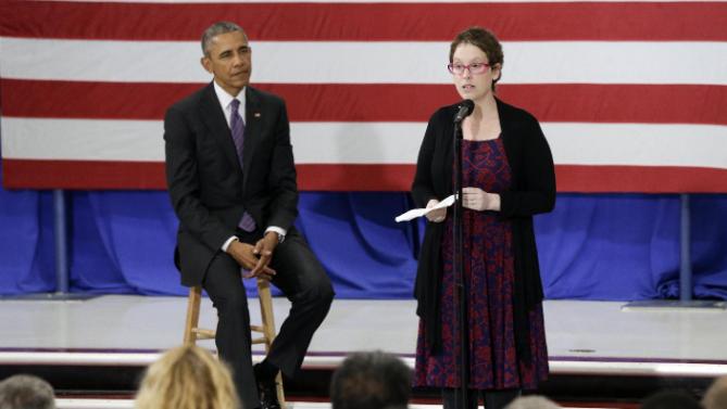 President Barack Obama listens as Kelly Bryant, right, a breast cancer survivor, introduces Obama at Taylor Stratton Elementary School Wednesday, July 1, 2015, in Nashville, Tenn. The president is in Nashville to speak about the Affordable Care Act. Bryant wrote to the president earlier this year to relay her positive experience with the Affordable Care Act. (AP Photo/Mark Humphrey)