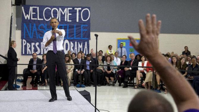 President Barack Obama takes a question from a man in the audience at Taylor Stratton Elementary School in Nashville, Tenn., Wednesday, July 1, 2015, where he spoke about the Affordable Care Act. The president said he wants to refocus on improving health care quality, expanding access and rooting out waste now that the Supreme Court has upheld a key element of his health care law. (AP Photo/Carolyn Kaster)