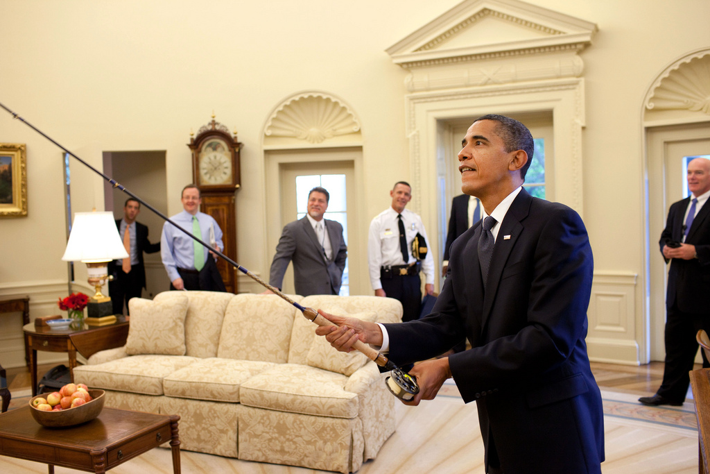 President Barack Obama tries out the fly fishing rod given to him on his birthday by a group of avid fisherman on his staff, August 4, 2009. (Official White House Photo by Pete Souza) This official White House photograph is being made available only for publication by news organizations and/or for personal use printing by the subject(s) of the photograph. The photograph may not be manipulated in any way and may not be used in commercial or political materials, advertisements, emails, products, promotions that in any way suggests approval or endorsement of the President, the First Family, or the White House.