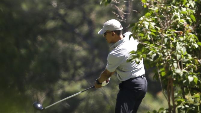 President Barack Obama tees off while golfing, Wednesday, Aug. 12, 2015, at Farm Neck Golf Club, in Oak Bluffs, Mass., on the island of Martha's Vineyard. The president, first lady Michelle Obama, and daughter Sasha are vacationing on the island. (AP Photo/Steven Senne)