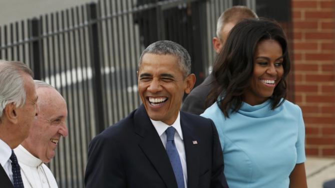U.S. President Barack Obama and first lady Michelle Obama smile as they walk with Pope Francis upon the Pontiff's arrival at Joint Base Andrews outside Washington September 22, 2015. REUTERS/Kevin Lamarque (TPX IMAGES OF THE DAY)