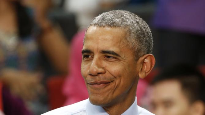 U.S. President Barack Obama smiles as he speaks at the Young Southeast Asian Leaders Initiative (YSEALI) during a town hall meeting at Taylor's University in Kuala Lumpur, Malaysia, Friday, Nov. 20, 2015. Obama urged young people in predominantly Muslim Malaysia on Friday to reject the terrible vision that drove the Paris attacks, offering an alternative vision in which traditional cultures coexist with a diverse modern world. (AP Photo/Vincent Thian)