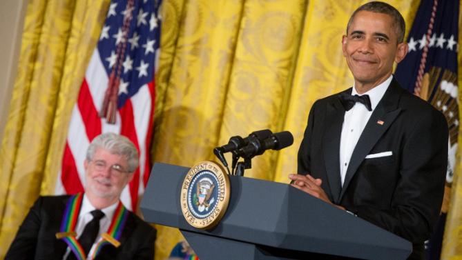 Filmmaker George Lucas, left, smiles as President Barack Obama pauses while speaking about him at the 2015 Kennedy Center Honors reception in the East Room of the White House in Washington, Sunday, Dec. 6, 2015, in Washington. The 2015 Kennedy Center Honors Honorees are singer-songwriter Carole King, filmmaker George Lucas, actress and singer Rita Moreno, conductor Seiji Ozawa, and actress Cicely Tyson. (AP Photo/Andrew Harnik)