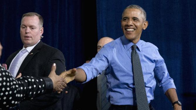 President Barack Obama shakes hands as he arrives to speak at the UAW-GM Center for Human Resources in Detroit, Wednesday, Jan. 20, 2016, to highlight the progress made by the city, its people and neighborhoods, and the American auto industry. (AP Photo/Carolyn Kaster)