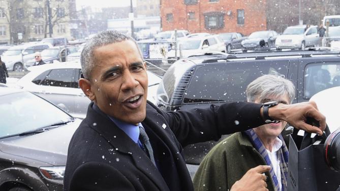 President Barack Obama responds to a bystander after visiting retail store Shinola in Detroit, Wednesday, Jan. 20, 2016. Someone yelled out, "Did you buy a watch?" Obama said, "I already have one," and pointed to the watch on his wrist. (Daniel Mears/Detroit News via AP, Pool)