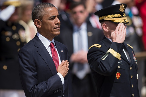 US President Barack Obama (L) and US Major General Bradley A. Becker, Commander of the Military District of Washington, listen to the US national anthem before placing a wreath at the Tomb of the Unknowns to honor Memorial Day at Arlington National CemeteryMay 30, 2016 in Arlington, Virginia. / AFP / Brendan Smialowski (Photo credit should read BRENDAN SMIALOWSKI/AFP/Getty Images)