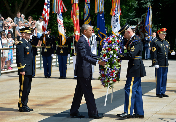 ARLINGTON, VA - MAY 30: (AFP-OUT) President Barack Obama is assisted as he lays a wreath at the Tomb of the Unknown Soldier at Arlington National Cemetery on May 30, 2016 in Arlington, Virginia. Obama paid tribute to the nation's fallen military service members. (Photo by Mike Theiler-Pool/Getty Images)