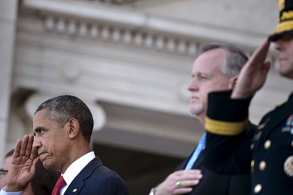 US President Barack Obama salutes during an event to honor Memorial Day at Arlington National Cemetery on May 30, 2016 in Arlington, Virginia. / AFP / Brendan Smialowski (Photo credit should read BRENDAN SMIALOWSKI/AFP/Getty Images)