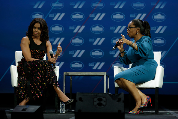 US First lady Michelle Obama (L) gestures next to Oprah Winfrey on a stage at the White House Summit on the United State of Women in Washington, DC on June 14, 2016. / AFP / YURI GRIPAS (Photo credit should read YURI GRIPAS/AFP/Getty Images)