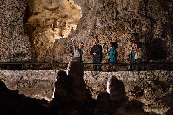 A US Park Ranger gives US President Barack Obama (2L), Sasha Obama (C), first lady Michelle Obama (2R) and Malia Obama a tour of Carlsbad Caverns National Park on June 17, 2016 in Carlsbad, New Mexico. / AFP / Brendan Smialowski (Photo credit should read BRENDAN SMIALOWSKI/AFP/Getty Images)