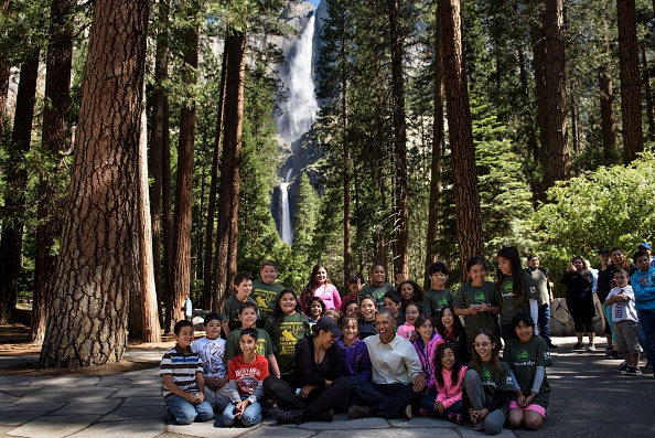 US First Lady Michelle Obama and US President Barack Obama sit with children after speaking to them about the "Every Kid in the Park" initiative while celebrating the 100th year of US National Parks, on June 18, 2016, in Yosemite National Park, California. / AFP / Brendan Smialowski (Photo credit should read BRENDAN SMIALOWSKI/AFP/Getty Images)