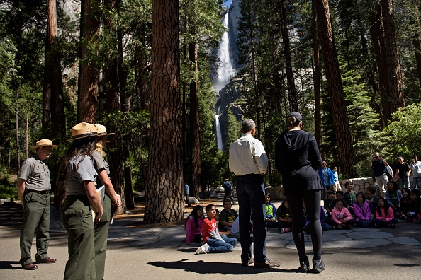 US First Lady Michelle Obama listens while US President Barack Obama speaks to children about the "Every Kid in the Park" initiative in Yosemite National Park, California, while celebrating the 100th year of US National Parks June 18, 2016. / AFP / Brendan Smialowski (Photo credit should read BRENDAN SMIALOWSKI/AFP/Getty Images)