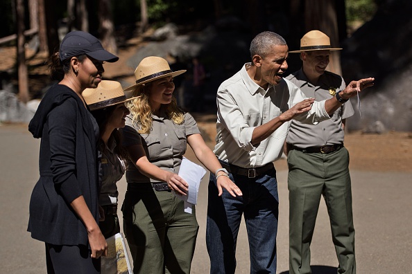 US First Lady Michelle Obama and others listen while US President Barack Obama shows how to scare a bear while speaking to children about the "Every Kid in the Park" initiative in Yosemite National Park, California, while celebrating the 100th year of US National Parks June 18, 2016. / AFP / Brendan Smialowski (Photo credit should read BRENDAN SMIALOWSKI/AFP/Getty Images)