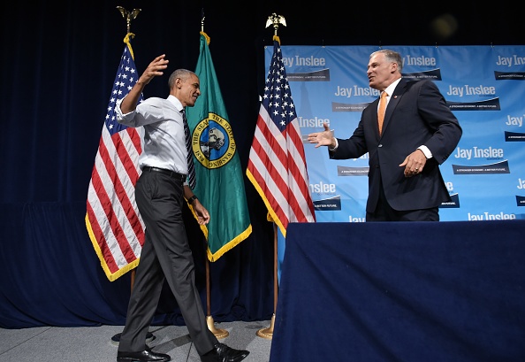Washington Governor Jay Inslee (R) greets US President Barack Obama after introducing him at a fundraiser at the Washington State Convention Center in Seattle, Washington on June 24, 2016. / AFP / MANDEL NGAN (Photo credit should read MANDEL NGAN/AFP/Getty Images)