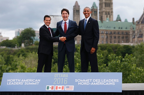 (L-R)Mexican President Enrique Pena Nieto, Canadian Prime Minister Justin Trudeau and US President Barack Obama pose for a group photo with Canada's Parliament Hill in the background during the North American Leaders Summit on June 29, 2016 in Ottawa, Ontario. / AFP / Chris Roussakis (Photo credit should read CHRIS ROUSSAKIS/AFP/Getty Images)