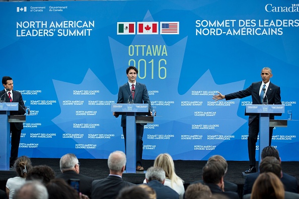 (L-R) Mexican President Enrique Pena Nieto, and Canadian Prime Minister Justin Trudeau look on as US President Barack Obama speaks during a trilateral press conference at the North American Leaders Summit at the National Gallery of Canada June 29, 2016 in Ottawa, Ontario. / AFP / Brendan Smialowski (Photo credit should read BRENDAN SMIALOWSKI/AFP/Getty Images)