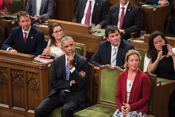 US President Barack Obama (L) waits with Sophie Gregoire Trudeau before addressing Parliament in the House of Commons Chamber on Parliament Hill while attending the North American Leaders Summit June 29, 2016 in Ottawa, Ontario. / AFP / Brendan Smialowski (Photo credit should read BRENDAN SMIALOWSKI/AFP/Getty Images)