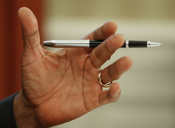 WASHINGTON, DC - JUNE 30: U.S.President Barack Obama holds a pen before signing a rescue package bill for Puerto Rico which is facing more than $70 billion in debt, in the Oval Office at the White House June 30, 2016 in Washington, DC. (Photo by Mark Wilson/Getty Images)