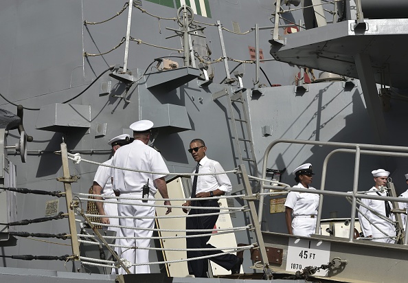 US President Barack Obama (C) arrives to tour the USS Ross Navy ship at the Naval Station Rota, in Rota, southwestern Spain on July 10, 2016. Obama said he will cut short a foreign trip and visit Dallas next week as the shooting rampage by the black army veteran, who said he wanted to kill white cops, triggered urgent calls to mend troubled race relations in the United States. / AFP / Mandel Ngan (Photo credit should read MANDEL NGAN/AFP/Getty Images)