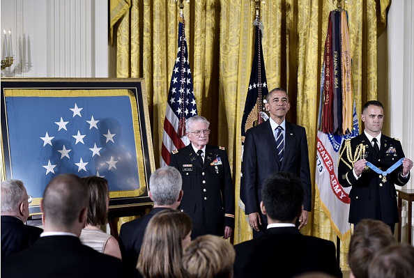US President Barack Obama and retired US Army Lt. Colonel Charles Kettles(L) listen as the citation is read during a presents the Medal of Honor ceremony in the East Room of the White House on July 18, 2016 in Washington, DC. Lt. Colonel Kettles was awarded the Medal of Honor for conspicuous gallantry while serving in Vietnam. / AFP / MANDEL NGAN (Photo credit should read MANDEL NGAN/AFP/Getty Images)