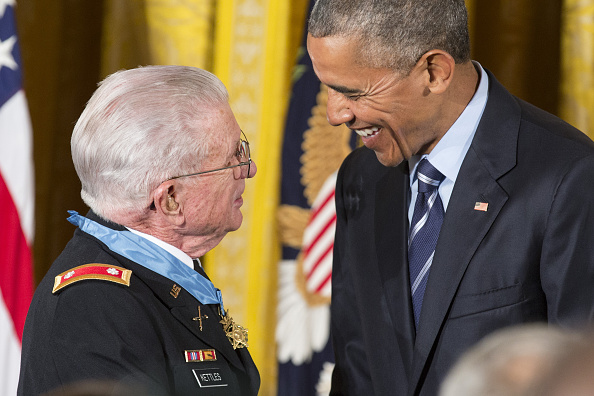 Vietnam War veteran Army Lieutenant Colonel Charles Kettles speaks with U.S. President Barack Obama after he was presented with the Medal of Honor at the White House in Washington, D.C., U.S., on Monday, July 18, 2016. Kettles led helicopter flights carrying reinforcements to U.S. soldiers and is credited with helping to save 40 soldiers and four members of his unit. Photographer: Joshua Roberts/Bloomberg via Getty Images