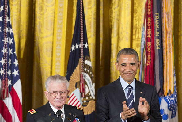 U.S. President Barack Obama applauds retired Army Lieutenant Colonel Charles Kettles during a Medal of Honor ceremony for the Vietnam War veteran at the White House in Washington, D.C., U.S., on Monday, July 18, 2016. Kettles led helicopter flights carrying reinforcements to U.S. soldiers and is credited with helping to save 40 soldiers and four members of his unit. Photographer: Joshua Roberts/Bloomberg via Getty Images
