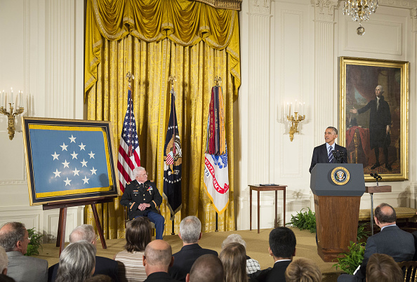 U.S. President Barack Obama addresses retired Army Lieutenant Colonel Charles Kettles during a Medal of Honor ceremony for the Vietnam War veteran at the White House in Washington, D.C., U.S., on Monday, July 18, 2016. Kettles led helicopter flights carrying reinforcements to U.S. soldiers and is credited with helping to save 40 soldiers and four members of his unit. Photographer: Joshua Roberts/Bloomberg via Getty Images