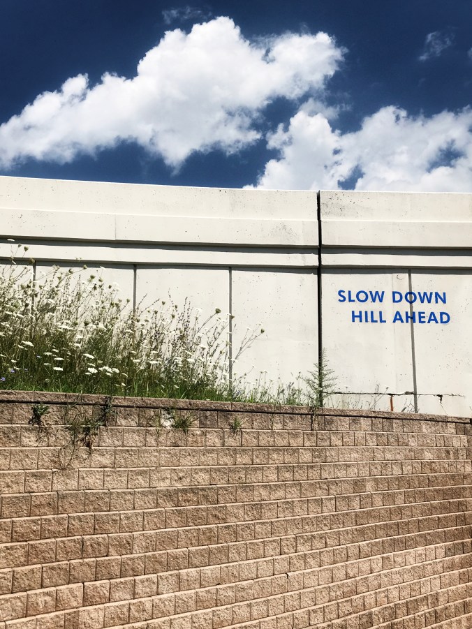 slow down for the clouds on the hill ahead