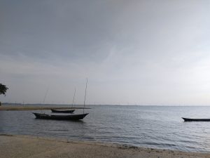 Evening river scene with some small boats are floating.