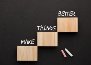 The words Make Things Better on wooden blocks in the shape of a staircase.