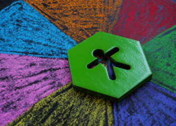 Figurine lies on multi-colored segments.