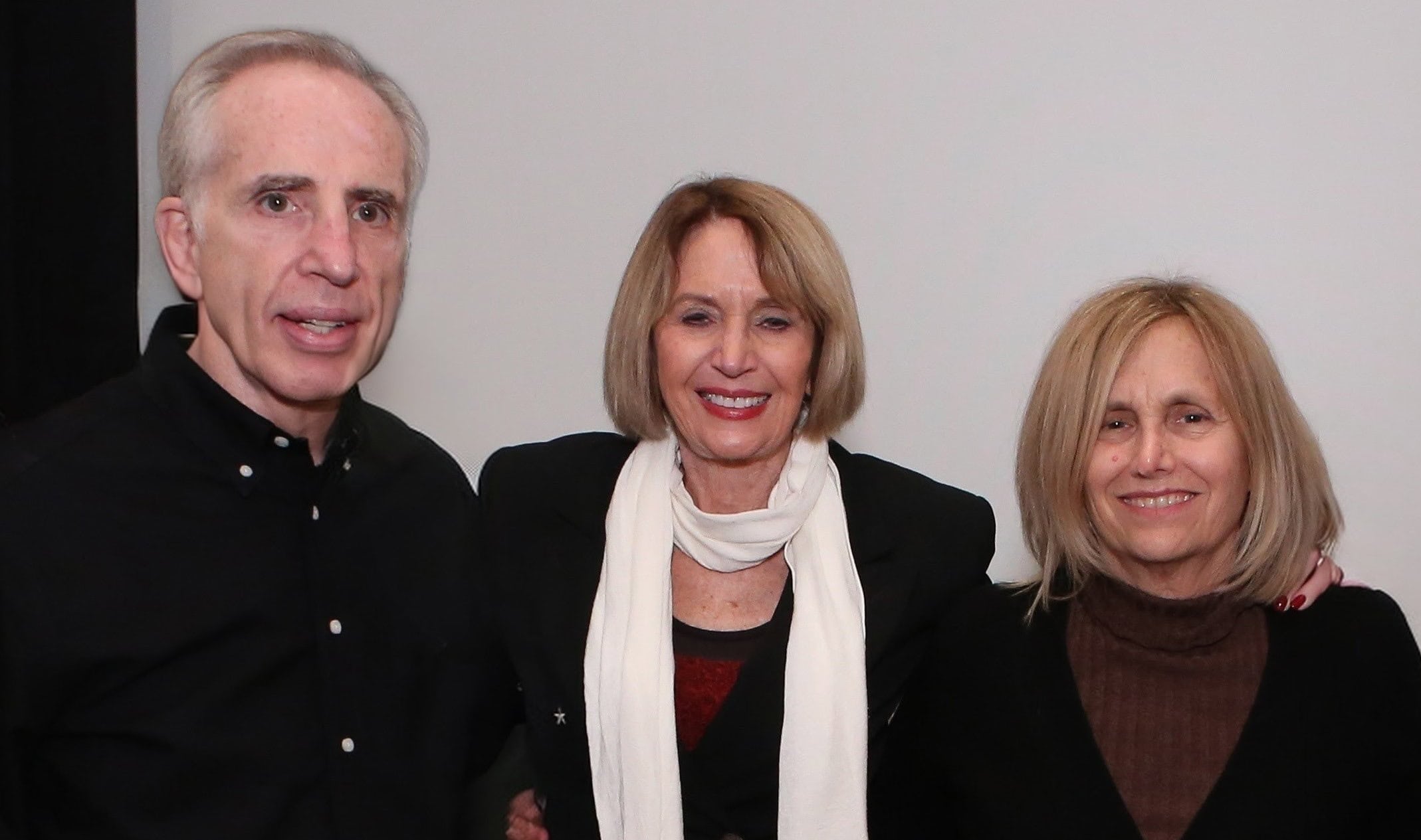 Marcia and Zuckers Website Three people standing together for a photo.
