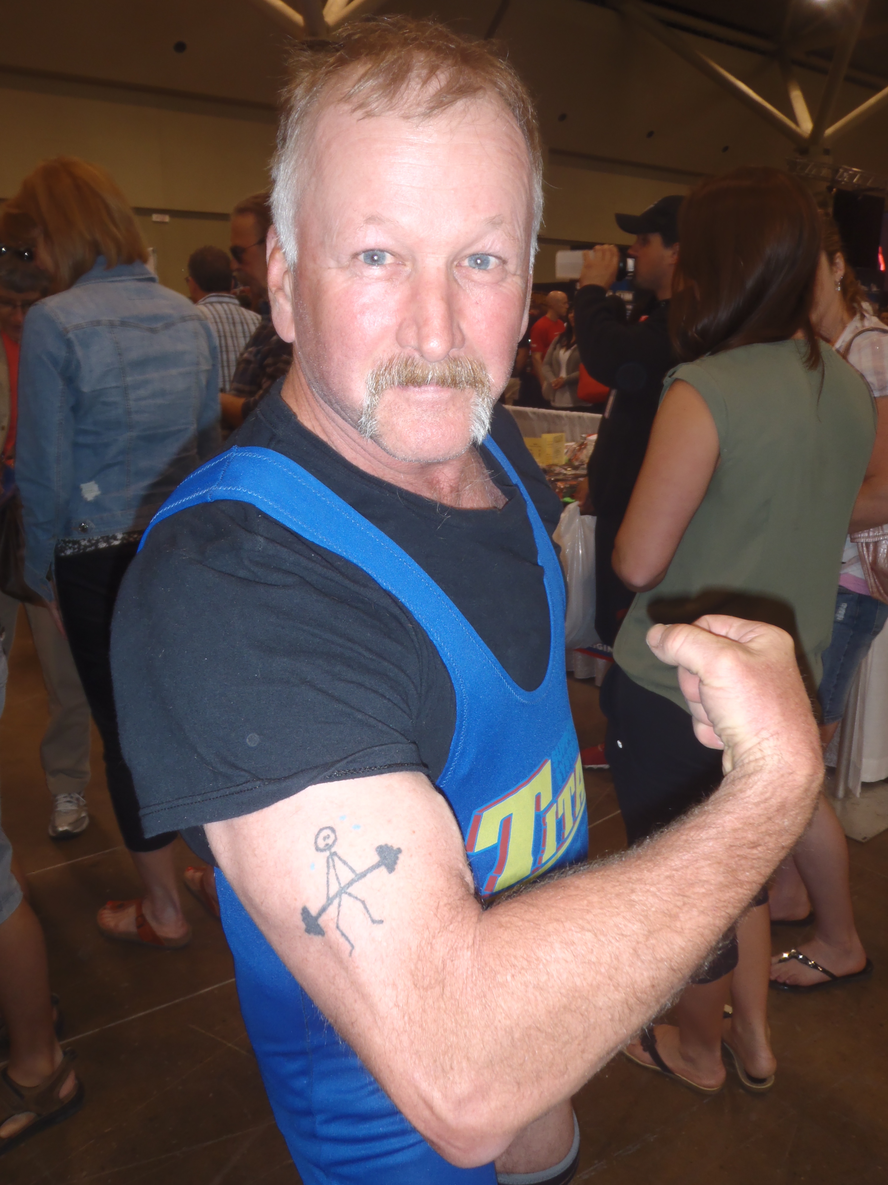 My dad, showing off the deadlift tattoo that I drew for him over ten years ago