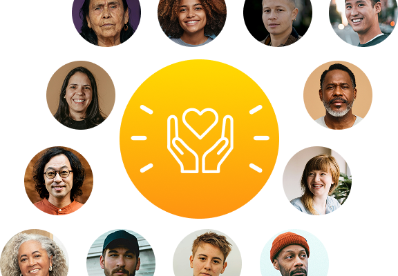 A woman stands confidently in the middle of a diverse crowd, raising a megaphone to her mouth as she addresses the gathered people. She wears casual clothing and her posture conveys determination and leadership.