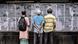 People stand in the street and read Bangladesh's local newspapers pasted along a wall in the capital Dhaka in September 2023 ahead of elections. People stand in the street and read Bangladesh's local newspapers pasted along a wall in the capital Dhaka in September 2023 ahead of elections.
