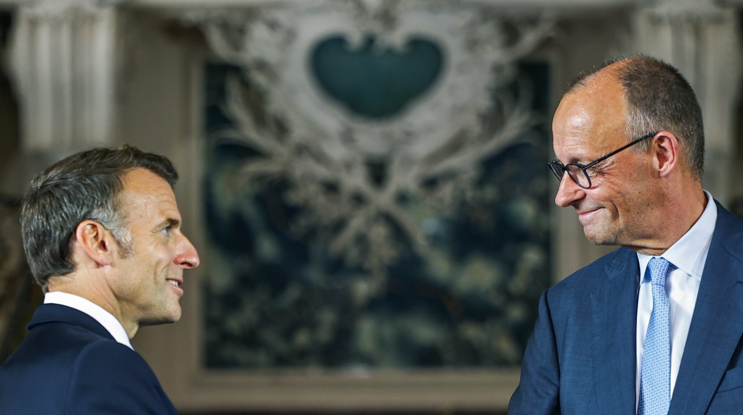 German Chancellor Friedrich Merz (R) and French President Emmanuel Macron (L)