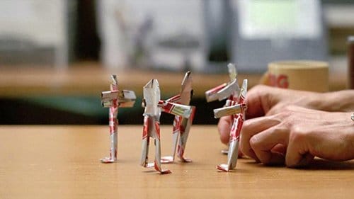 While telling his story to detectives, Rustin Cohle weirdly transforms five cans of beer in to five little people and places them in a circle. Is he unconsciously telling the detectives who are the real culprits and that he never caught them?