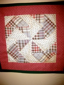 One block from a quilt of "The Flying Windmill" pattern. Turn it on it's side and it's the Nazi symbol.