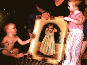 My daughter, holding the portrait of Baby Grace, given to her daughter Grace and her son Gannon when they are 2 and 1.