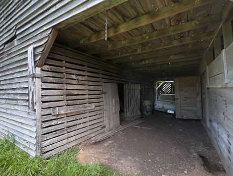 joe_9212-comp You are looking at the livestock side of the barn, above. There were two "rooms." The door to the second "room" is just to the left of the car. The stairs to the second floor are also in that room. It is presumed that one side was for beasts of burdern, horses and mules. And the other side was for cattle.