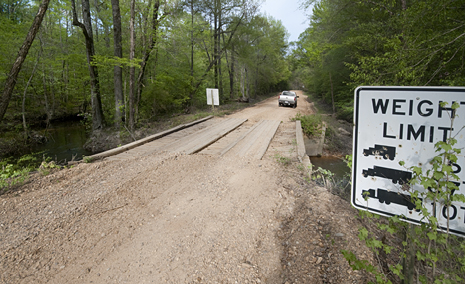 shortcut-joe-4_9288 Gravel roads and wooden bridges are old hat down here. To those in urban areas maybe not. So, take a gander at the wooden bridge on my shortcut.
