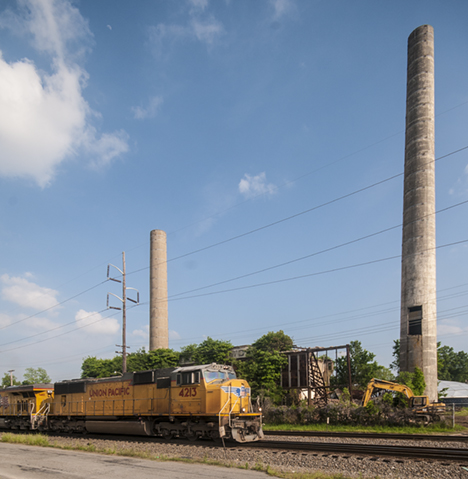 Train in front of old power plant