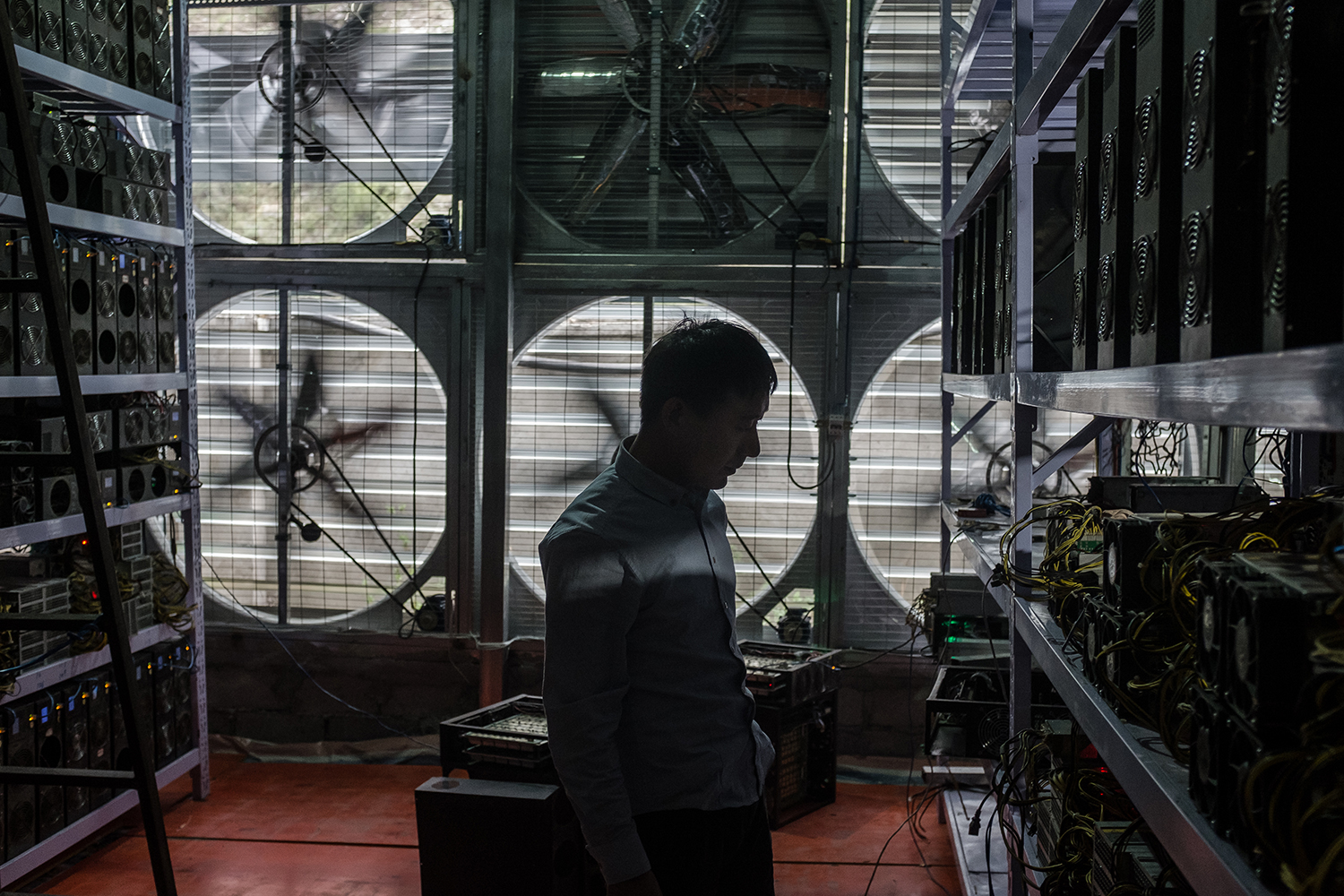 Liu, 29, stands in front of a wall of cooling fans at his Bitcoin mine where he houses and operates mining machines for miners who don’t want to move to rural Sichuan, in Ngawa Tibetan and Qiang Autonomous Prefecture, Sichuan province, September 27, 2016.