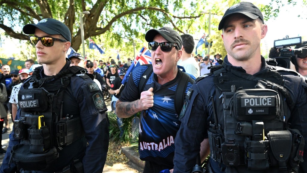 Police and anti-immigration protesters in Brisbane (Image: AAP/Darren England)