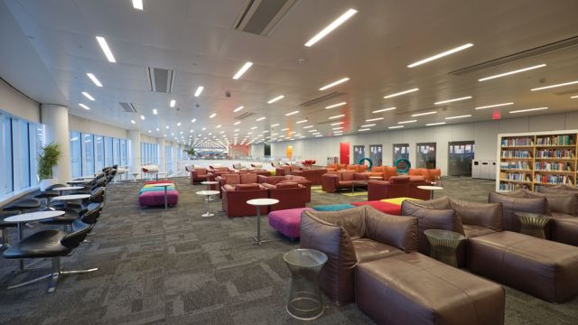Lounge seating with book shelves and music booths in the background.
