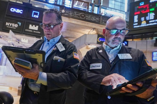 AP26154534475573 Traders Edward Curran and Fred Demarco work on the floor of the New York Stock Exchange.