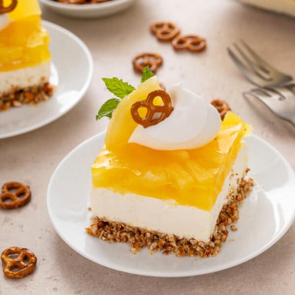 Slice of pineapple pretzel salad on a white plate.