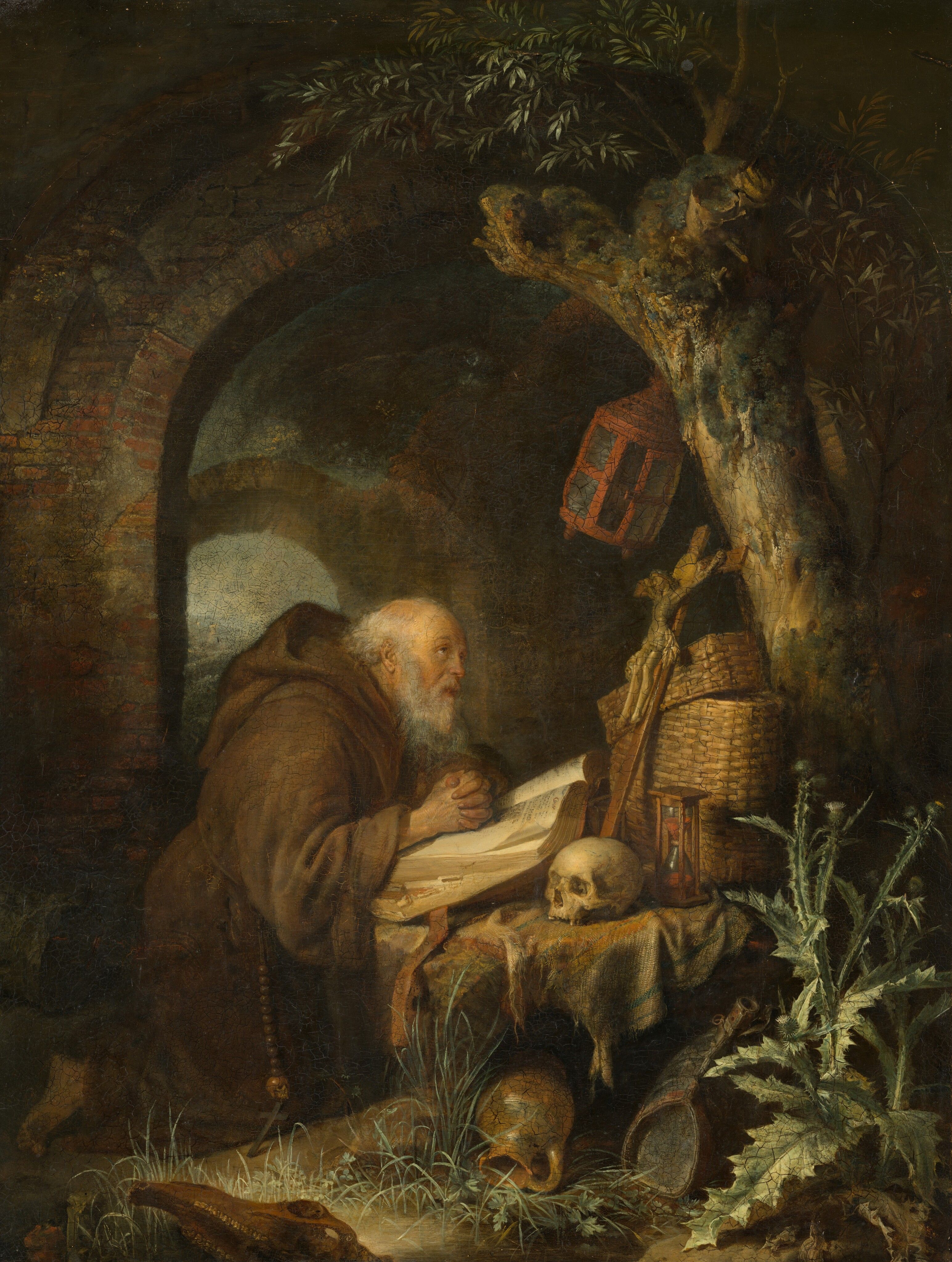 Tableau "The Hermit" du peintre néerlandais Gerrit Dou (1613-1675), représentant un ermite franciscain priant les mains posées sur la Bible (1670).